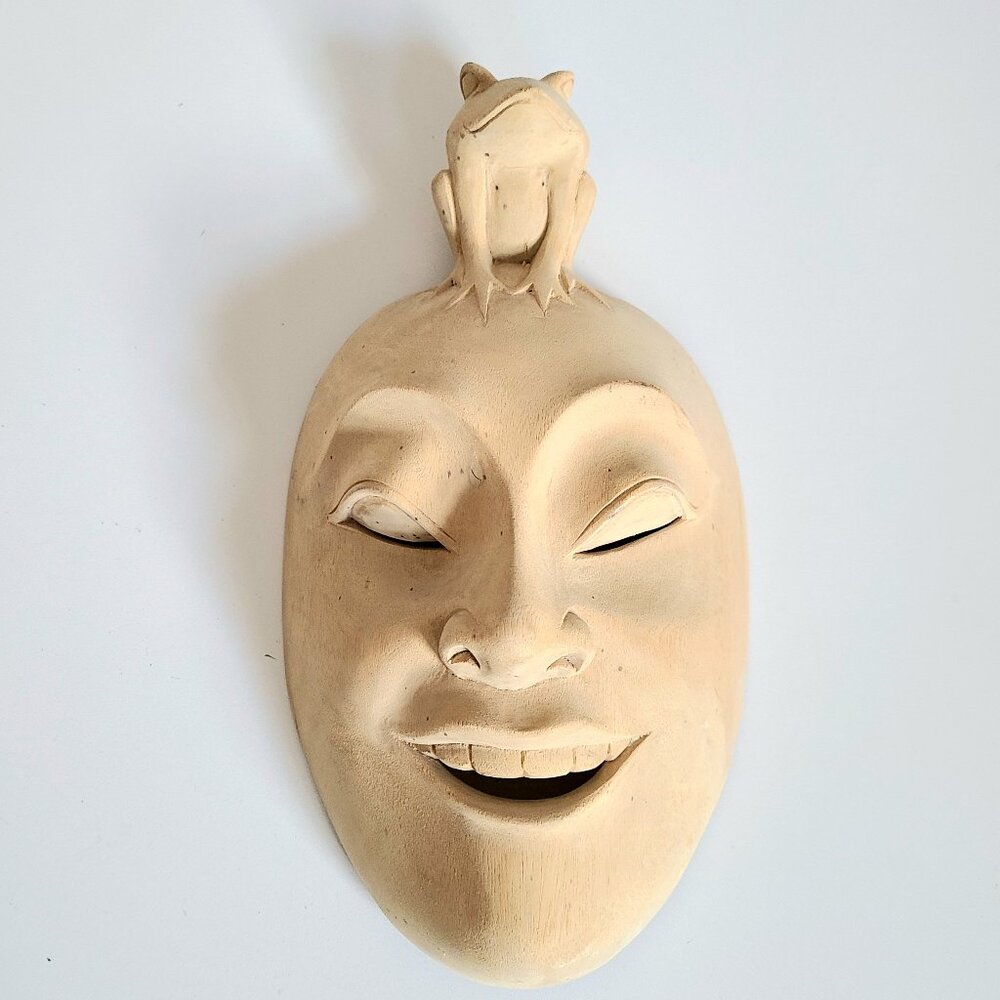 Hibiscus wooden handmade face mask with frog on top from Bali.